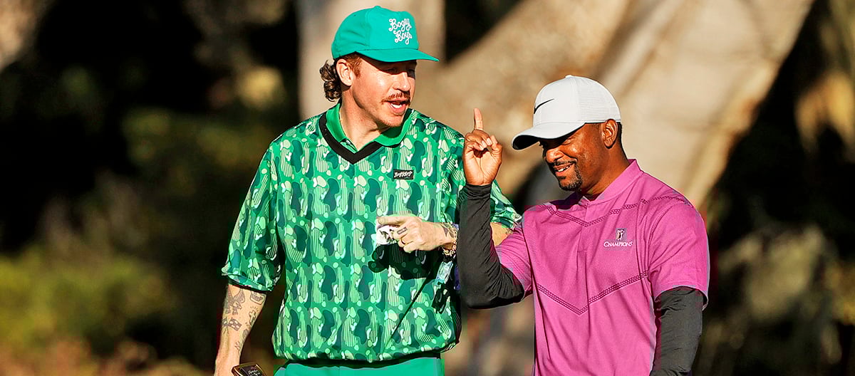 Singer Macklemore congratulates his playing partner actor Alfonso Ribeiro after Ribeiro made a putt on the second hole for the Charity Challenge at AT&T Pebble Beach Pro-Am on February 10, 2021 at Pebble Beach Golf Links in Pebble Beach, California.